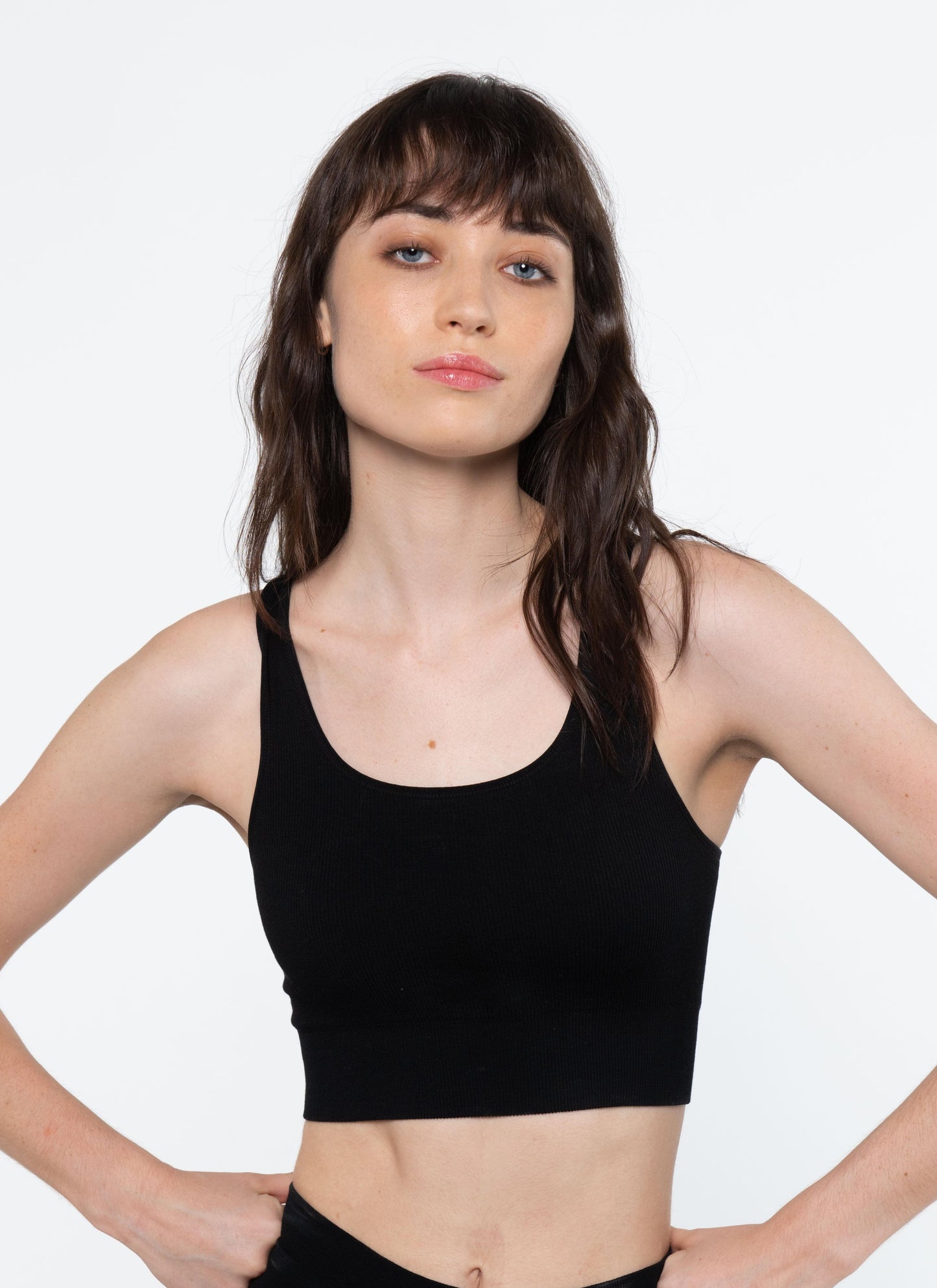 Black crop tank top with wide straps and scoop neckline, fitted