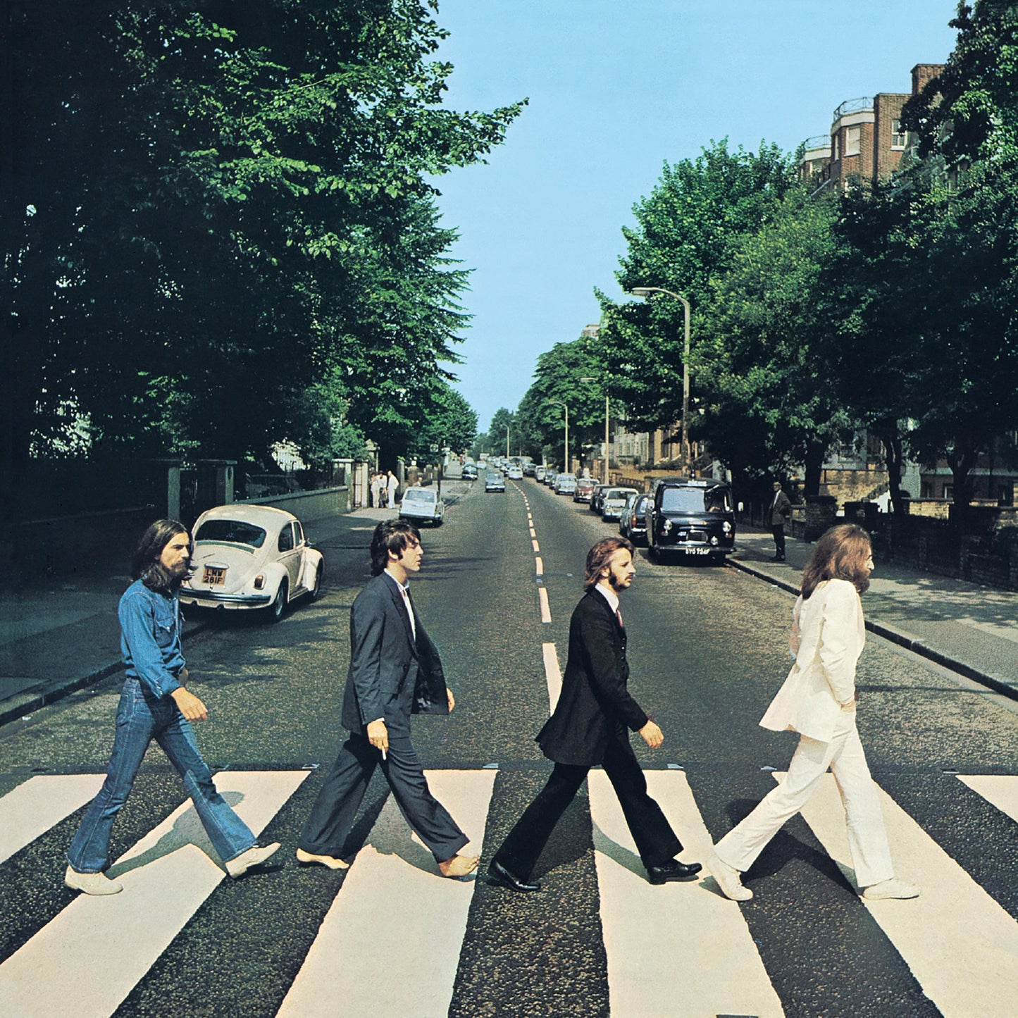 Four people walking down a city street