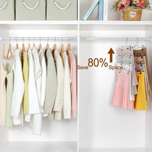 Four-tier hangers holding pants and skirts with black clips in a closet