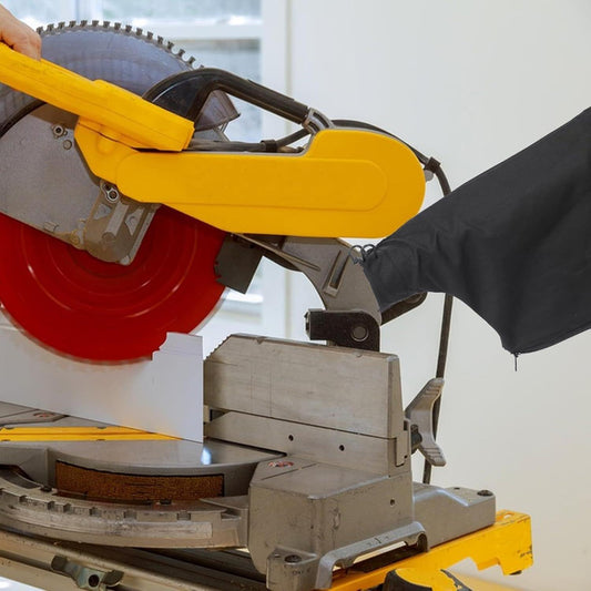 Black dust bag attached to a miter saw outlet for collecting debris