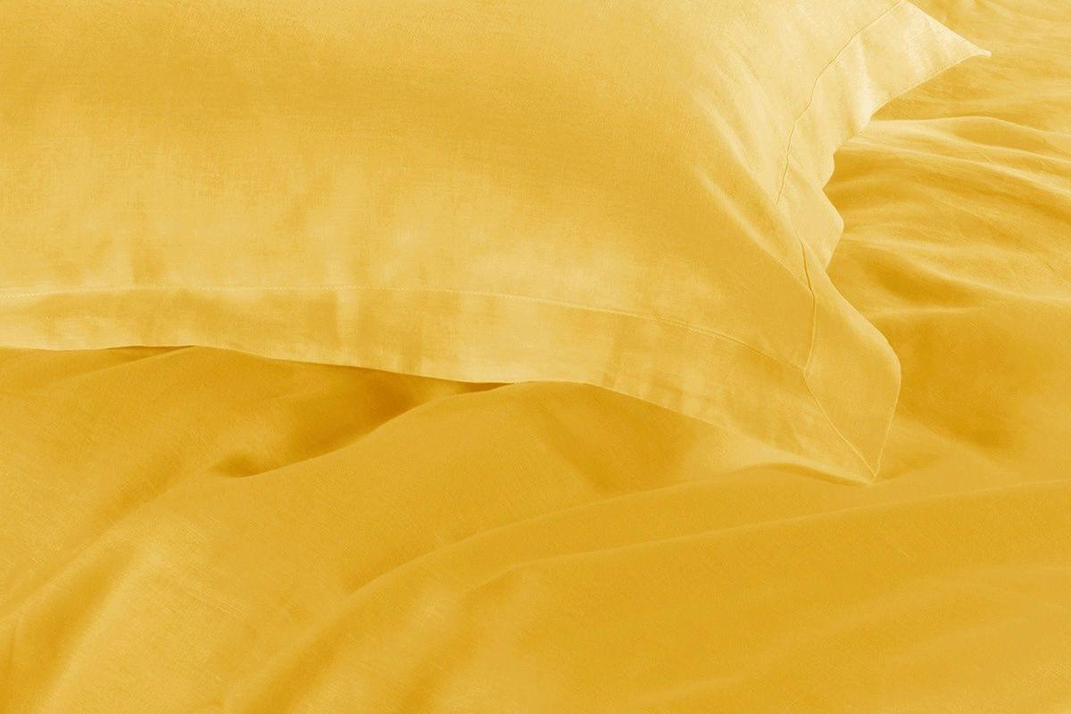 Yellow quilt cover close-up with smooth, slightly textured fabric