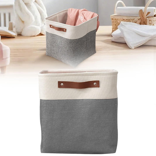 Two-tone fabric storage bag with brown handle strap, gray body, open top with folded cloth