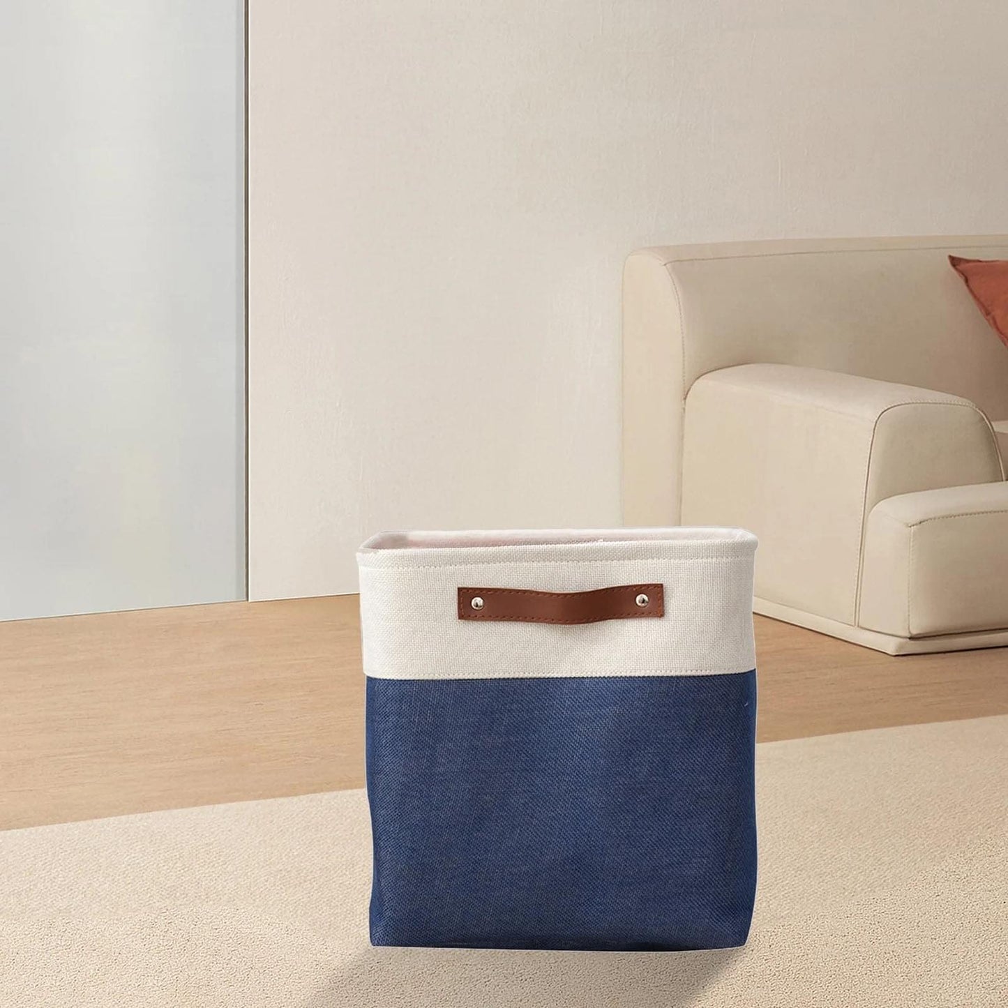 Two-tone fabric storage bag with cream top, blue bottom, and brown leather handle tabs