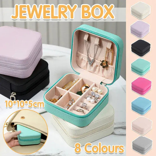 Green travel jewelry organizer box with open tray compartments for rings and earrings