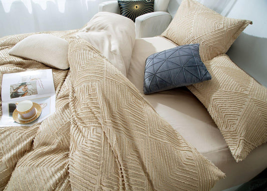 Tufted jacquard quilt cover draped over bed, textured diamond pattern
