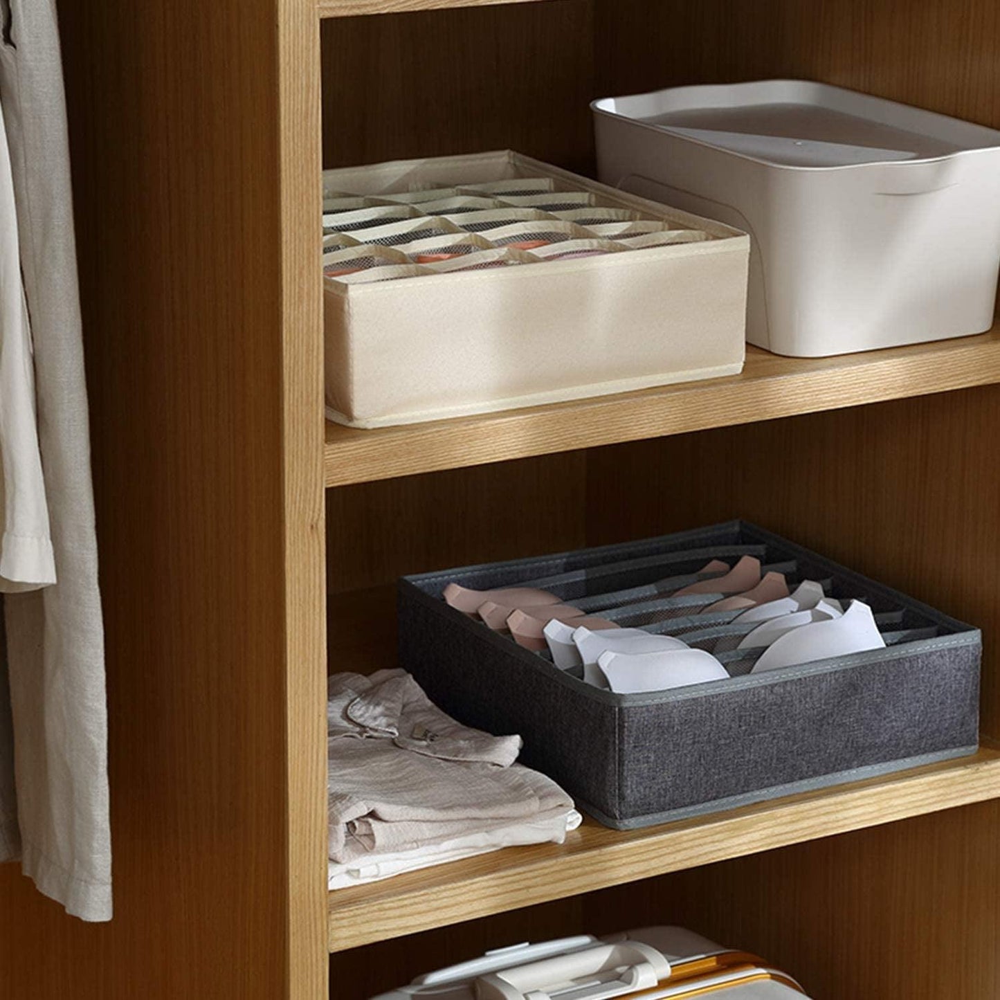Dark gray fabric drawer organizer bin with compartments holding folded clothes