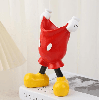 Red cat-shaped brush holder with white arms and legs, yellow feet, and open top