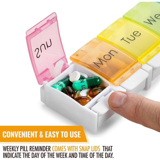 Weekly pill organizer open with day bins and assorted pills; hand pushing a lid