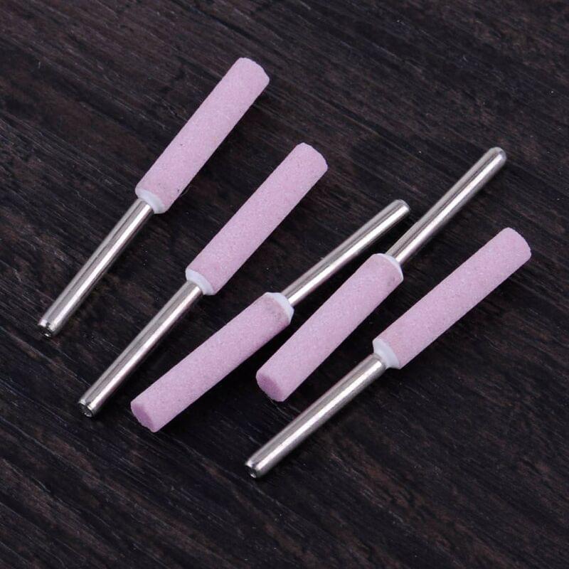 Five pink chainsaw sharpening grinding stone heads with metal shafts