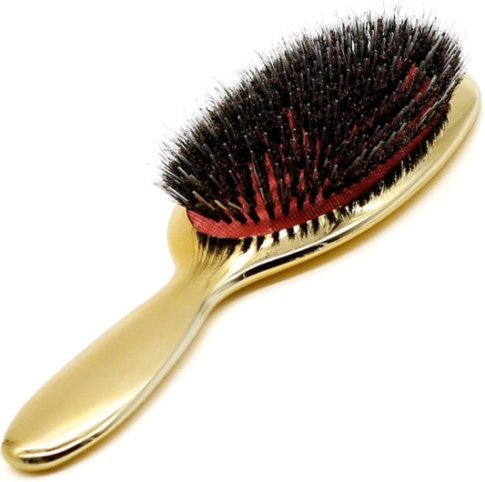 Gold extension hairbrush with dark bristles and red cushion base