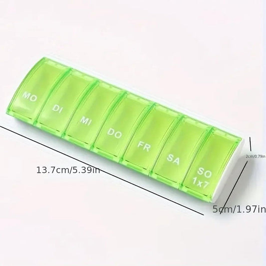 Green 7-day pill organizer with labeled compartments and size markings