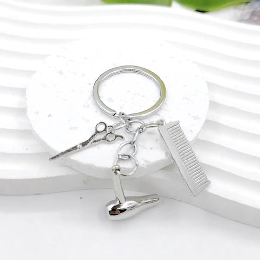 Silver hairdresser keychain with ring, comb, scissors, and hairdryer charm