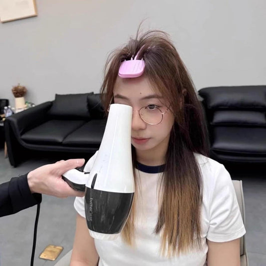 Pink sectioning hair clip holding hair at the root