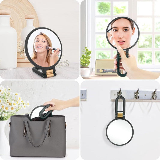 Portable round magnifying mirror, black frame with hinged folding handle and gold inserts