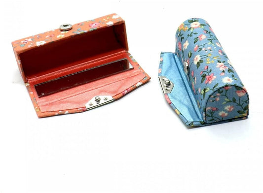 Lipstick case organizer set, shown open: blue and orange cases with mirror and compartments