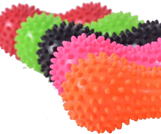 Close-up spiky peanut-shaped massage balls in orange, pink, green, and black