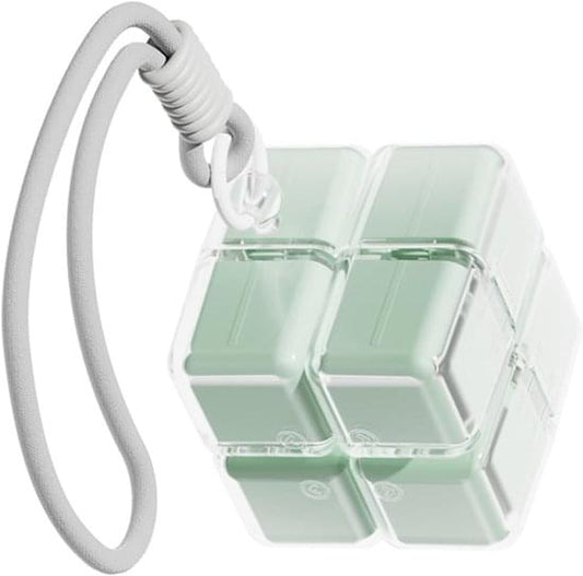 Open green weekly pill box showing four compartment wells with cord handle