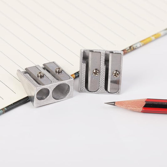 Metal pencil sharpener open with double holes and two blade screws.
