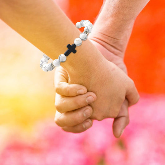 Cross beaded bracelet on an open hand with elastic stretch beads