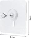 Self-adhesive nail hook with round adhesive backing and metal screw, close-up
