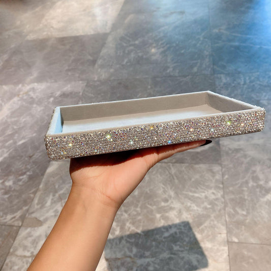Rectangular jewelry tray side view with sparkling rhinestone trim and beige interior