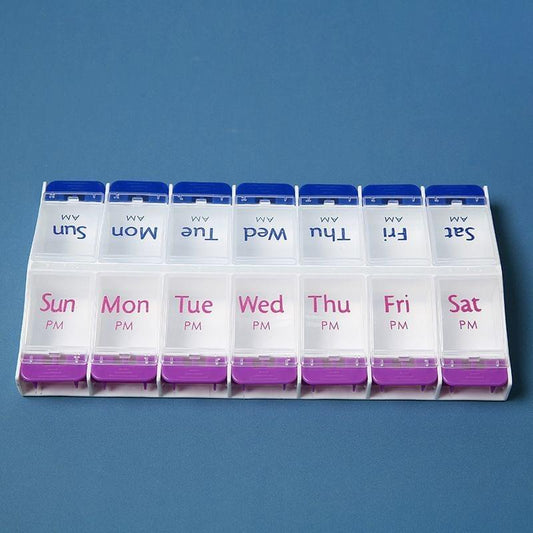 14-grid pill box with blue lid and purple base, weekly day labels across rows