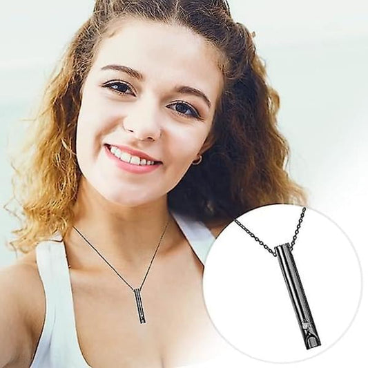 Black breathing necklace pendant with chain on a woman, inset close-up view