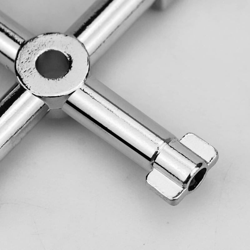 Close-up of cross-joint universal wrench with silver socket end and ring hole
