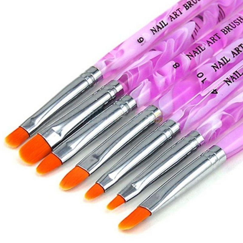 Close-up of acrylic nail art brushes, purple handles with orange bristles