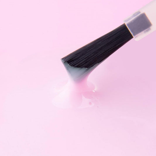 UV gel brush applying glossy light pink gel