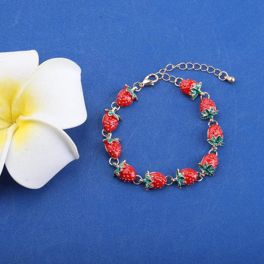Strawberry charm bracelet with red strawberry beads, green leaves, and gold chain