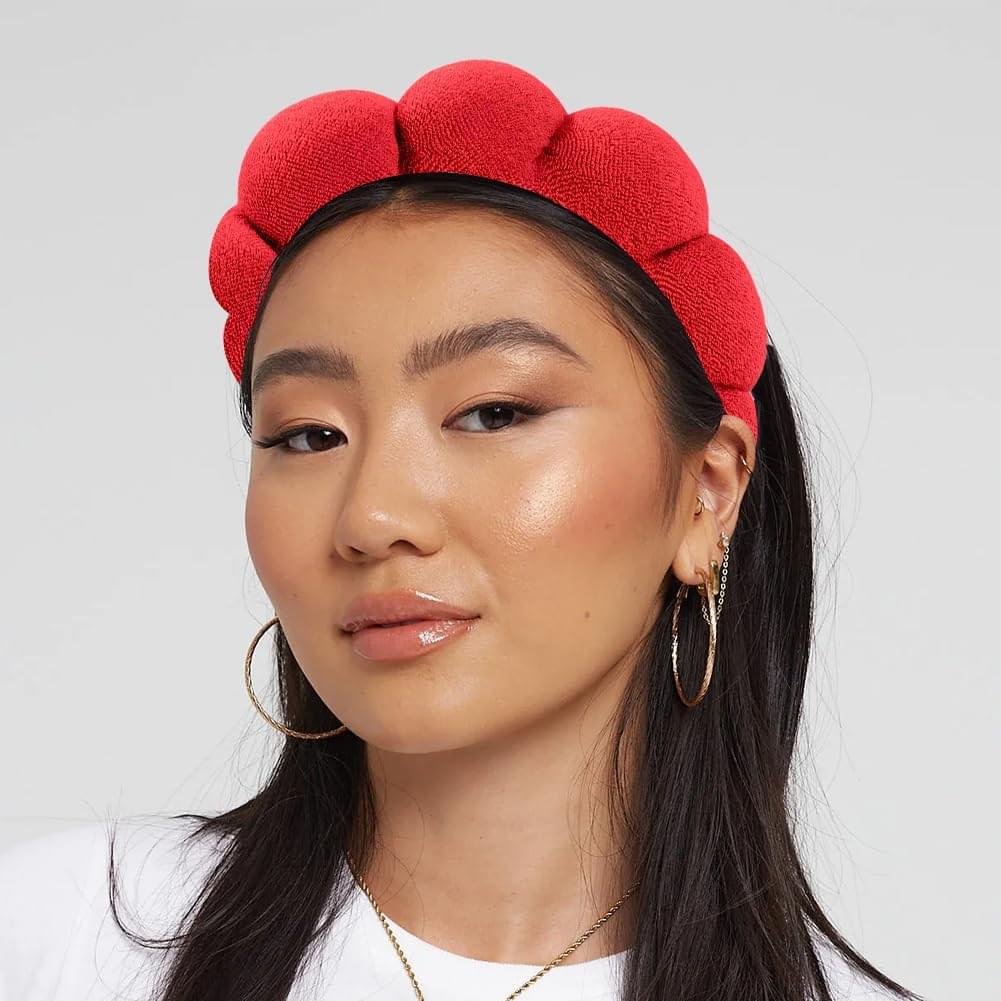 Red bubble terry cloth headband with rounded loops, worn by model