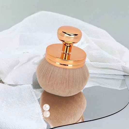 Large kabuki self-tan brush with round tan bristle head and rose-gold cap