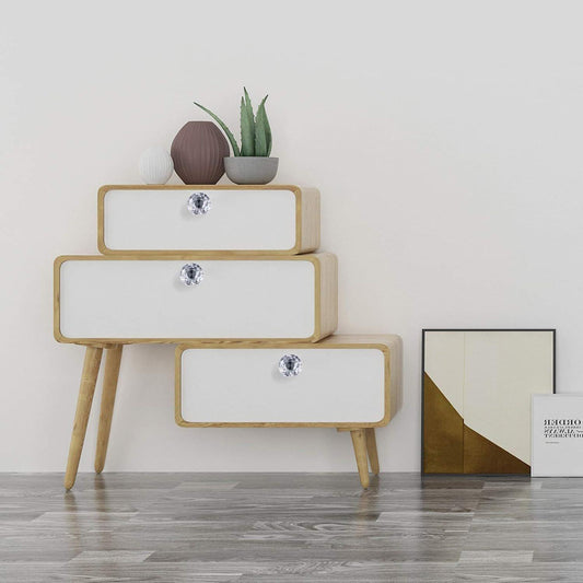 Crystal drawer knobs on white cabinet drawers, faceted diamond glass with silver bases