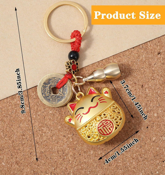 Lucky cat keychain with gold charm, red tassel, and round coin disc