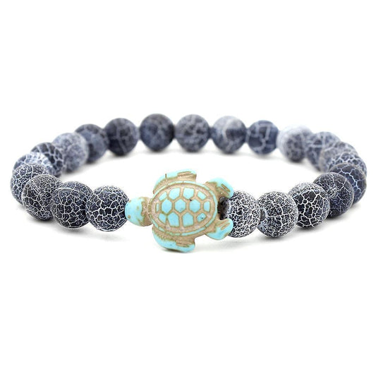 Dark blue beaded bracelet with turquoise turtle charm and cracked pattern, elastic fit