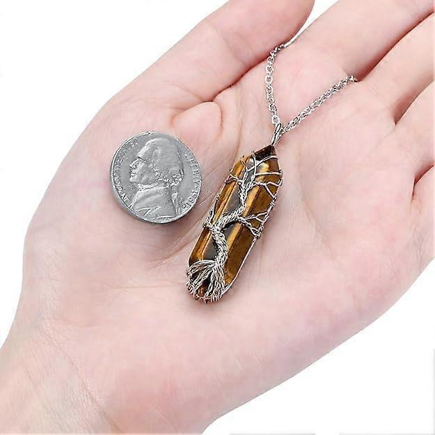 Silver chain necklace with amber wire-wrapped crystal pendant held in open palm