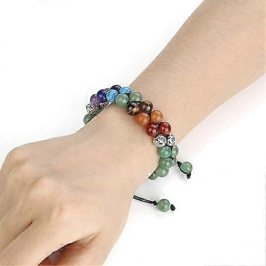 Multicolor crystal bead bracelet on wrist with silver charm spacers and macrame tie