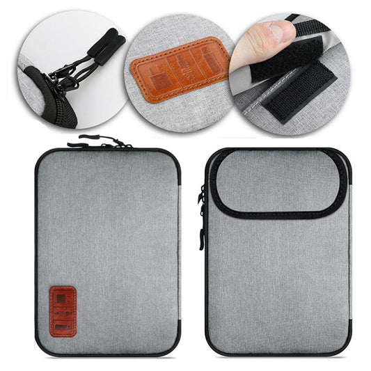 Grey cable storage travel bag with black trim and brown leather patch on front