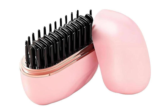 Pink mini hair straightening comb with open hinged case and black heating prongs