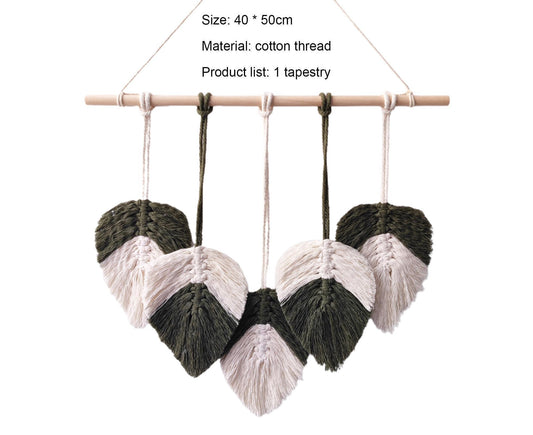 Macrame wall hanging with alternating white and dark green tassel clusters on a bar