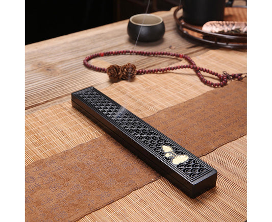 Black incense stick holder, embossed circles with small flower detail at center