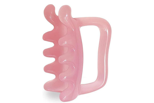 Pink handheld massager tool with arched handle and wavy ridged edge