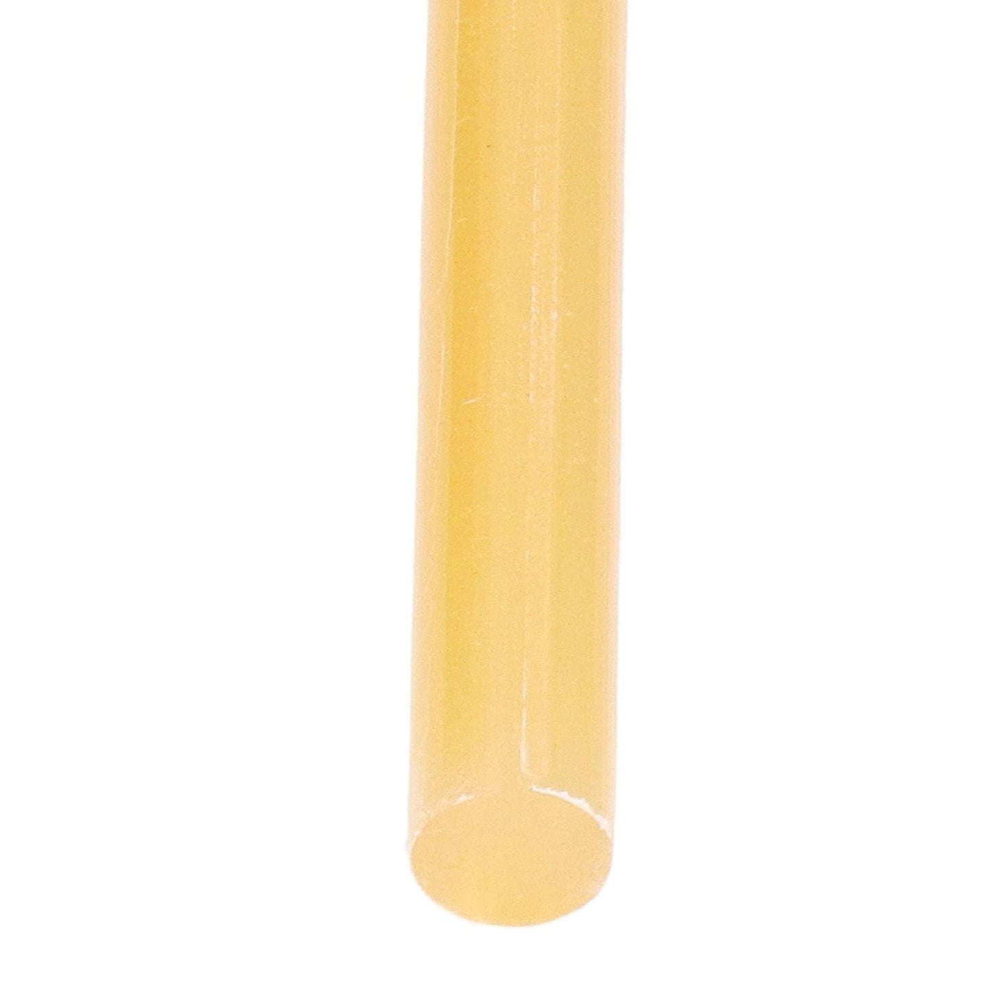 Yellow hot melt glue stick, rounded end tip close-up