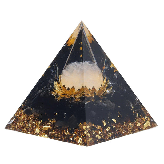 Orgone pyramid decoration, dark with gold glitter, and clear spherical crystal at center