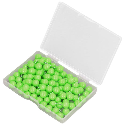 Green push pins in a clear plastic box with the lid open, metal pin tips visible
