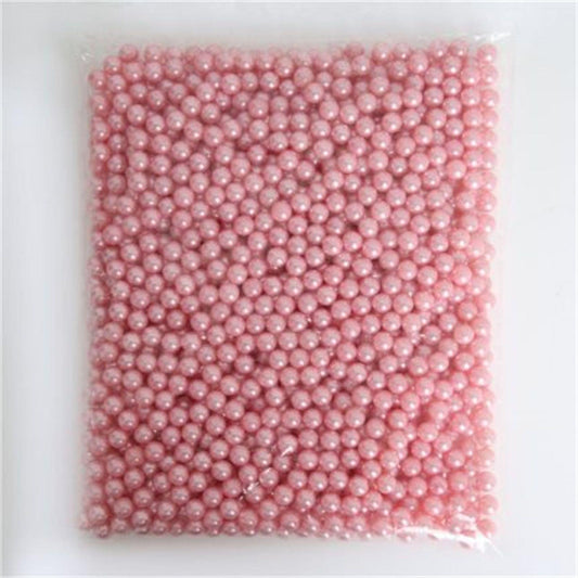 Pink faux pearl beads in clear square bag, evenly filled