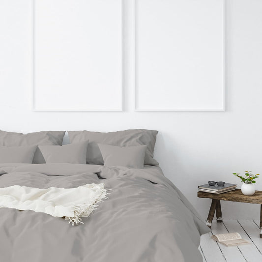 Dove gray pillowcases with white lace accent on a queen bed