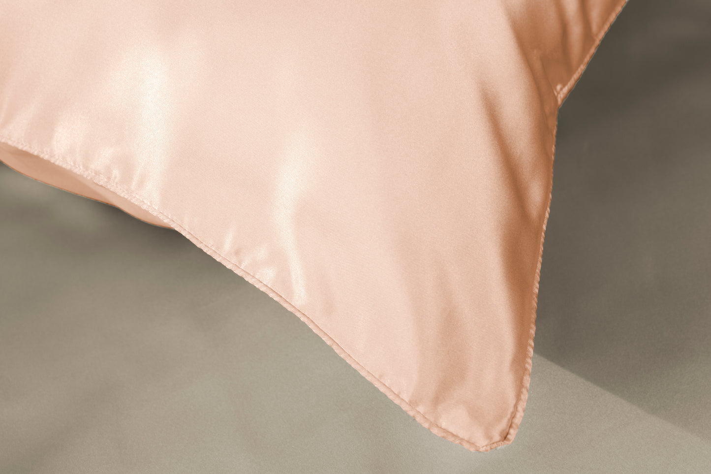 Peach silk pillowcase corner with neat hem and soft satin finish