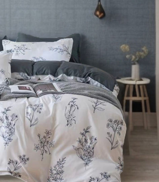 Queen quilt cover close-up: white fabric with blue-gray floral sprigs and gray accents